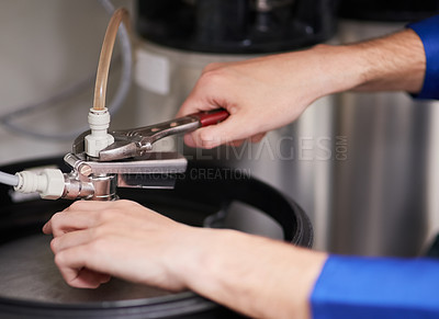 Buy stock photo Cropped shot of a handyman repairing a pipe on a water heater