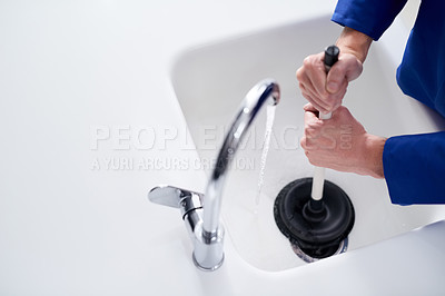 Buy stock photo Cropped shot of a plumber	 unblocking a drain with a plunger