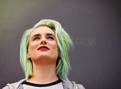 Buy stock photo Shot of a trendy young woman with mint green hair posing against a gray background