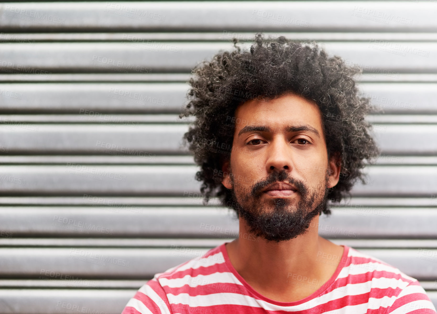 Buy stock photo Portrait of a young man with curly hair standing outside