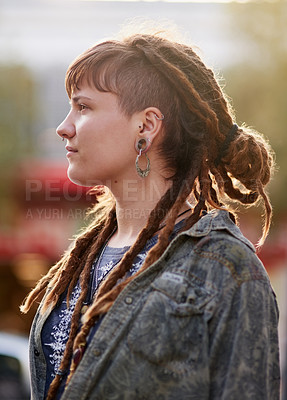 Buy stock photo Shot of a young woman with dreadlocks and piercings posing outdoors