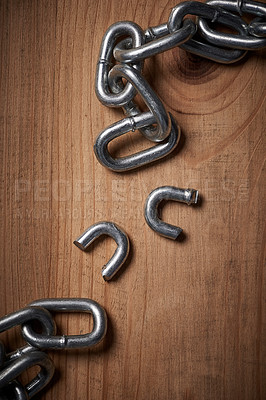 Buy stock photo Freedom, security and broken metal chain for mental health, conflict and power on wood background. Steel, link and divorce from connection, stress and resilience in change, independence or liberation