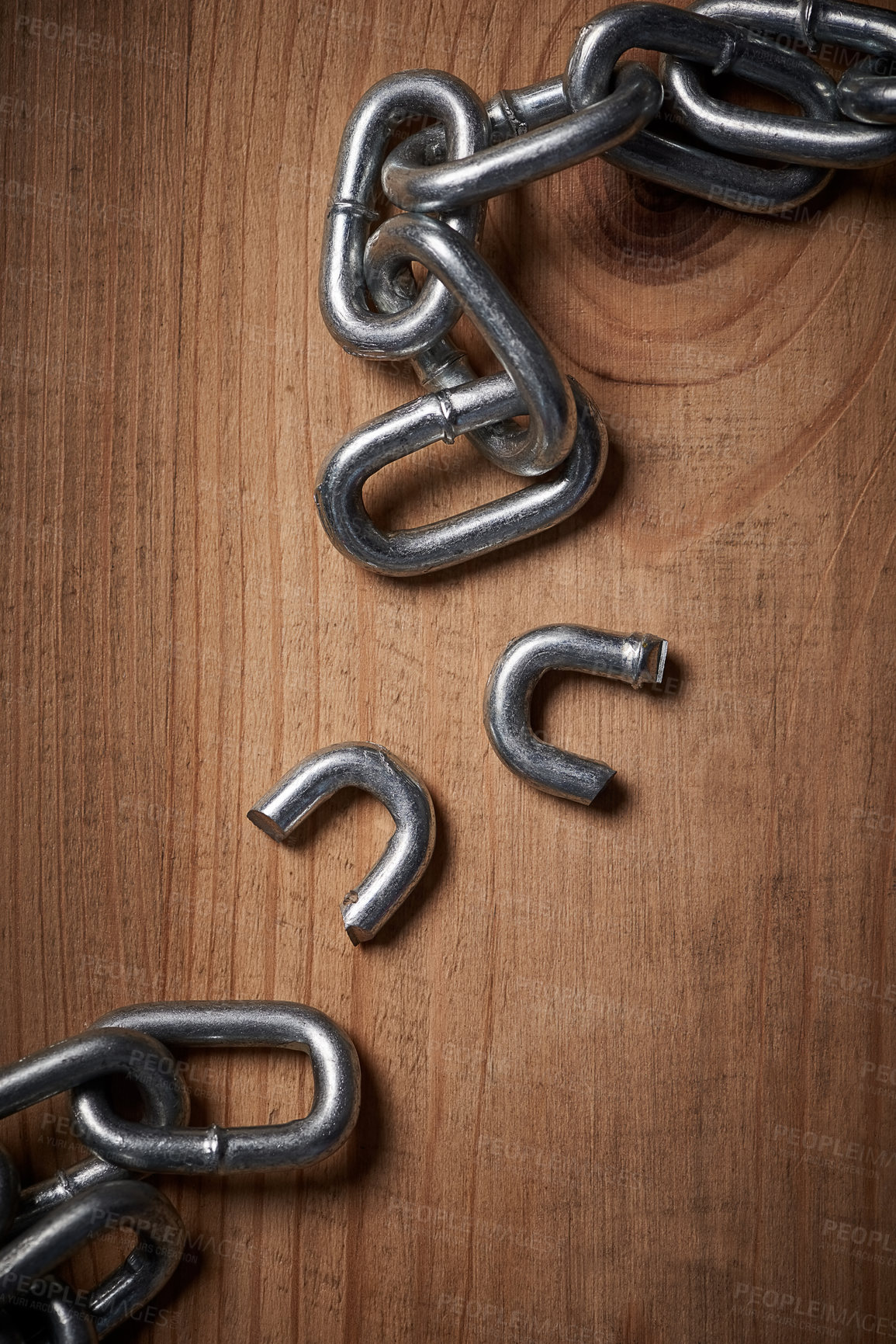 Buy stock photo Freedom, security and broken metal chain for mental health, conflict and power on wood background. Steel, link and divorce from connection, stress and resilience in change, independence or liberation