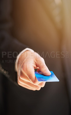 Buy stock photo Cropped shot of a businessman holding out a credit card as payment