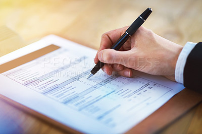 Buy stock photo Cropped shot of a person filling in a form