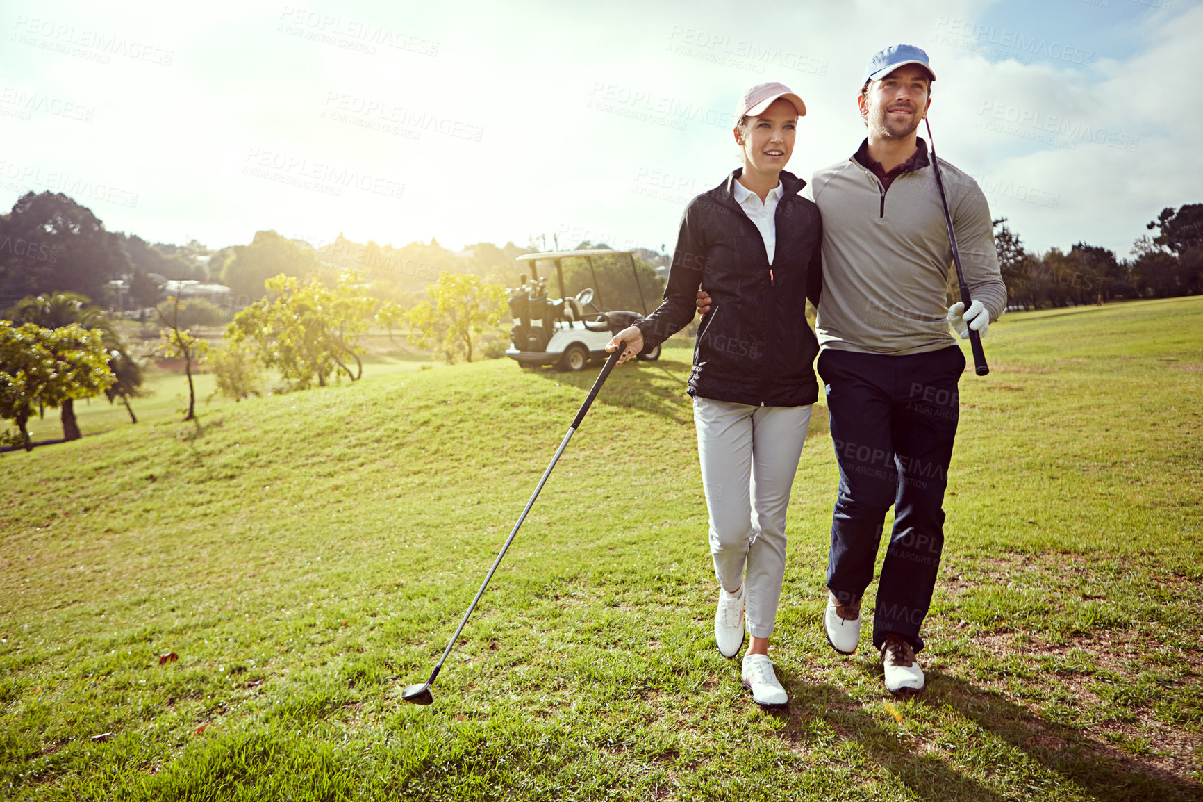 Buy stock photo Golf, nature and couple on course for sports together at country club for leisure activity. Lensflare, happy and young man and woman with smile playing game for bonding, hobby or date outdoor.