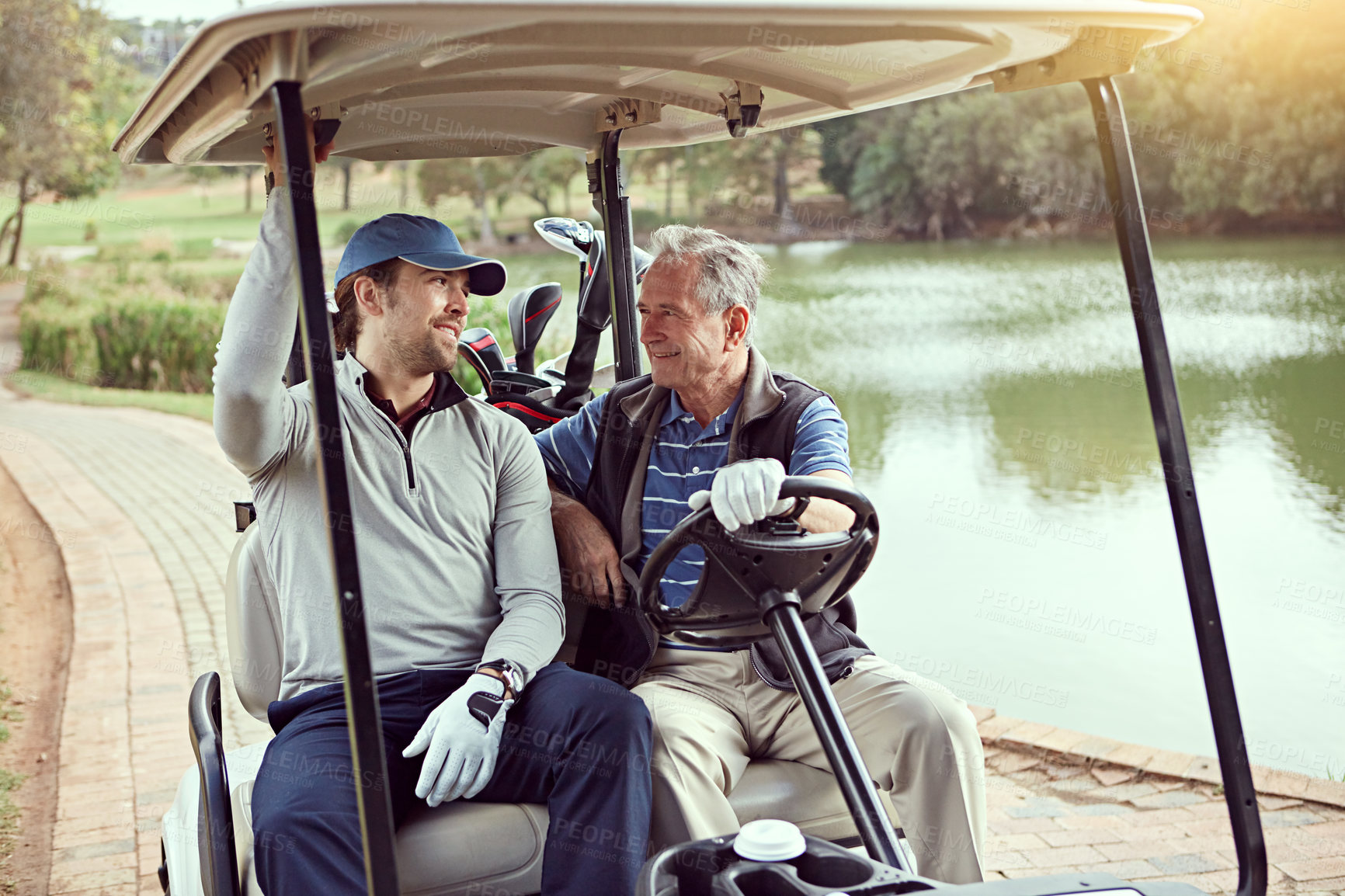 Buy stock photo Men, driving and golf cart for sports, exercise and recreation with weekend hobby, bonding and fitness. Senior parent, man and happy on course for game, practice and fun club competition with talking