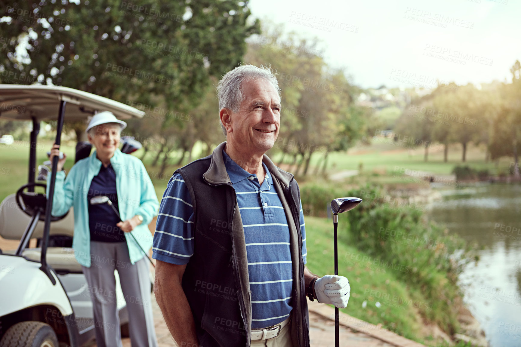 Buy stock photo Shot of a smiling senior couple enjoying a day on the golf course