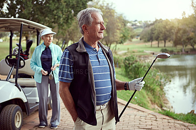Buy stock photo Shot of a senior couple enjoying a day on the golf course