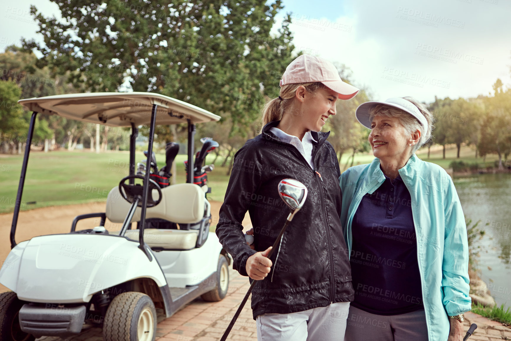 Buy stock photo Golf, women and holiday on course with hug, bonding and sport together outdoor for fun. Grandmother, cart and game with club, fitness and workout for health and wellness with love, joy and golfer