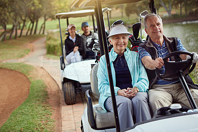 Buy stock photo Shot of a smiling senior couple riding in a cart on a golf course