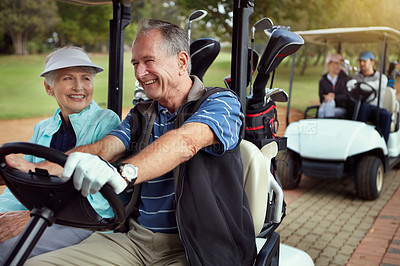 Buy stock photo Shot of a smiling senior couple riding in a cart on a golf course
