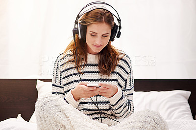 Buy stock photo Cropped shot of a beautiful young woman listening to music at home