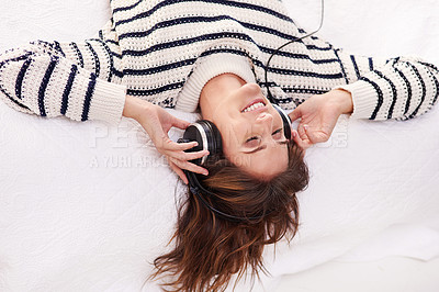 Buy stock photo Relax, music and happy woman on bed with headphones from above, happiness and wellness in home. Audio, smile and girl in bedroom listening to streaming radio service or podcast with peace and freedom