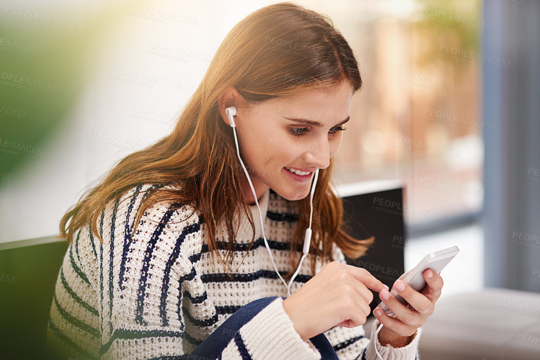 Buy stock photo Cropped shot of a beautiful young woman listening to music at home