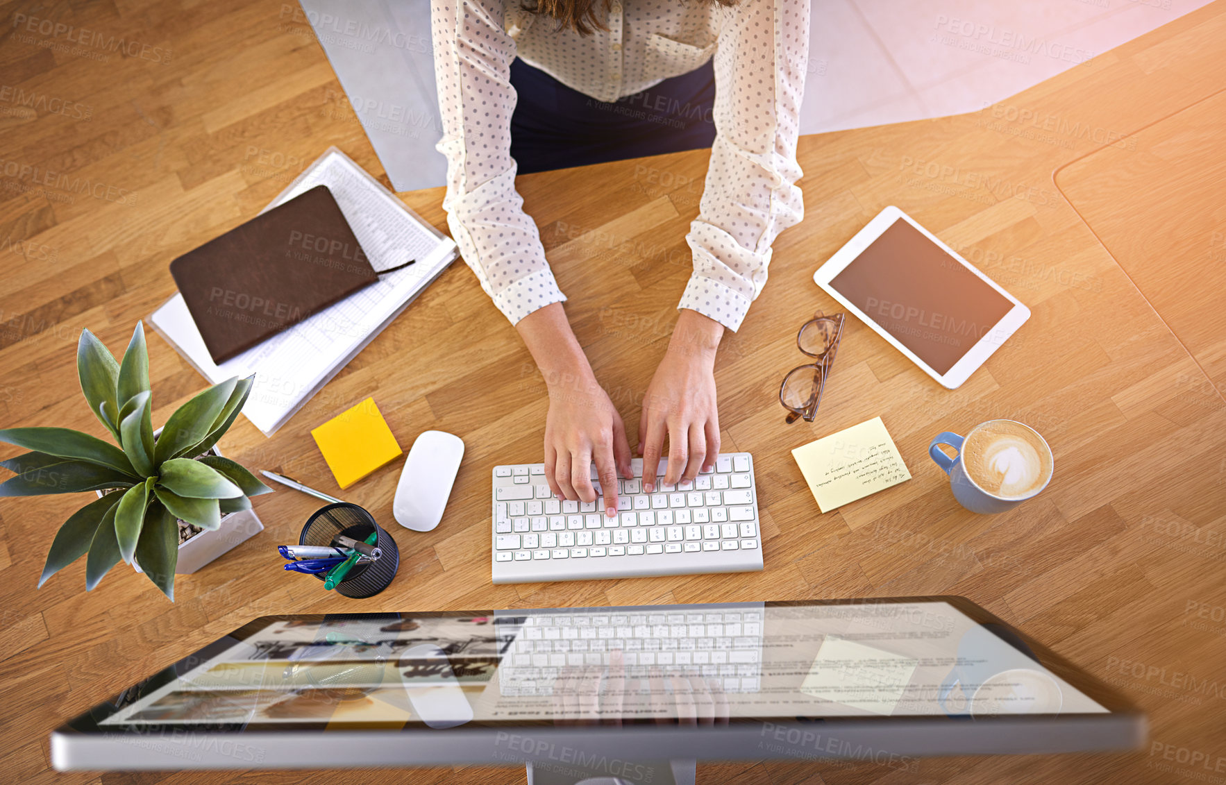 Buy stock photo Cropped shot of a young businesswoman working on a computer in an office