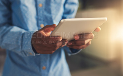Buy stock photo Cropped shot of a businessman using his digital tablet