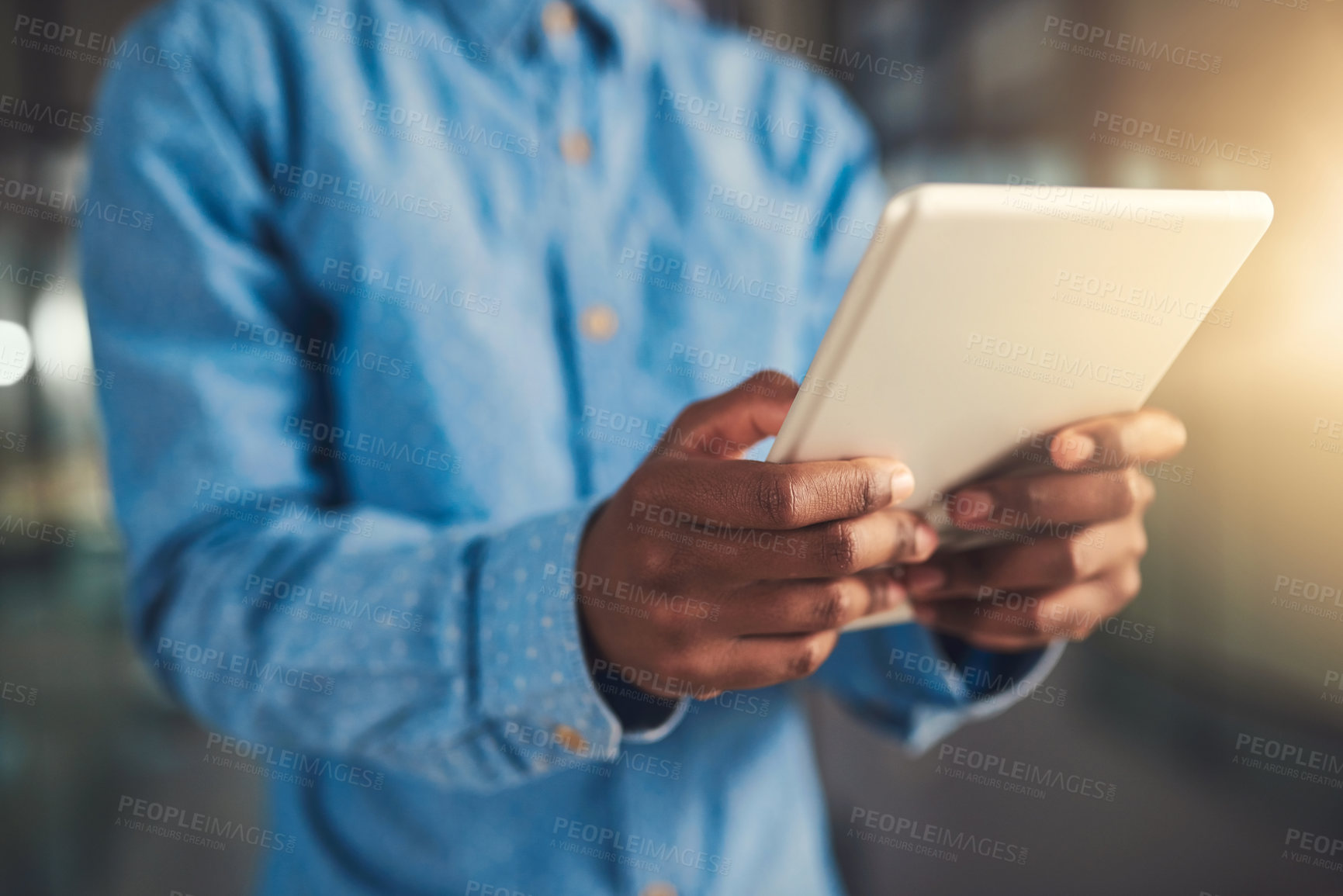 Buy stock photo Cropped shot of a businessman using his digital tablet