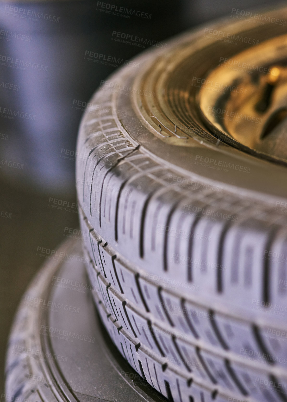 Buy stock photo Tyres, stack and wheel in garage for repair, rubber and fixing or replace fitting on car at shop. Closeup, workshop and service or safety check as inspection, motor and alignment of vehicle to change