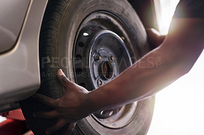 Buy stock photo Cropped shot of a mechanic repairing a car tyre