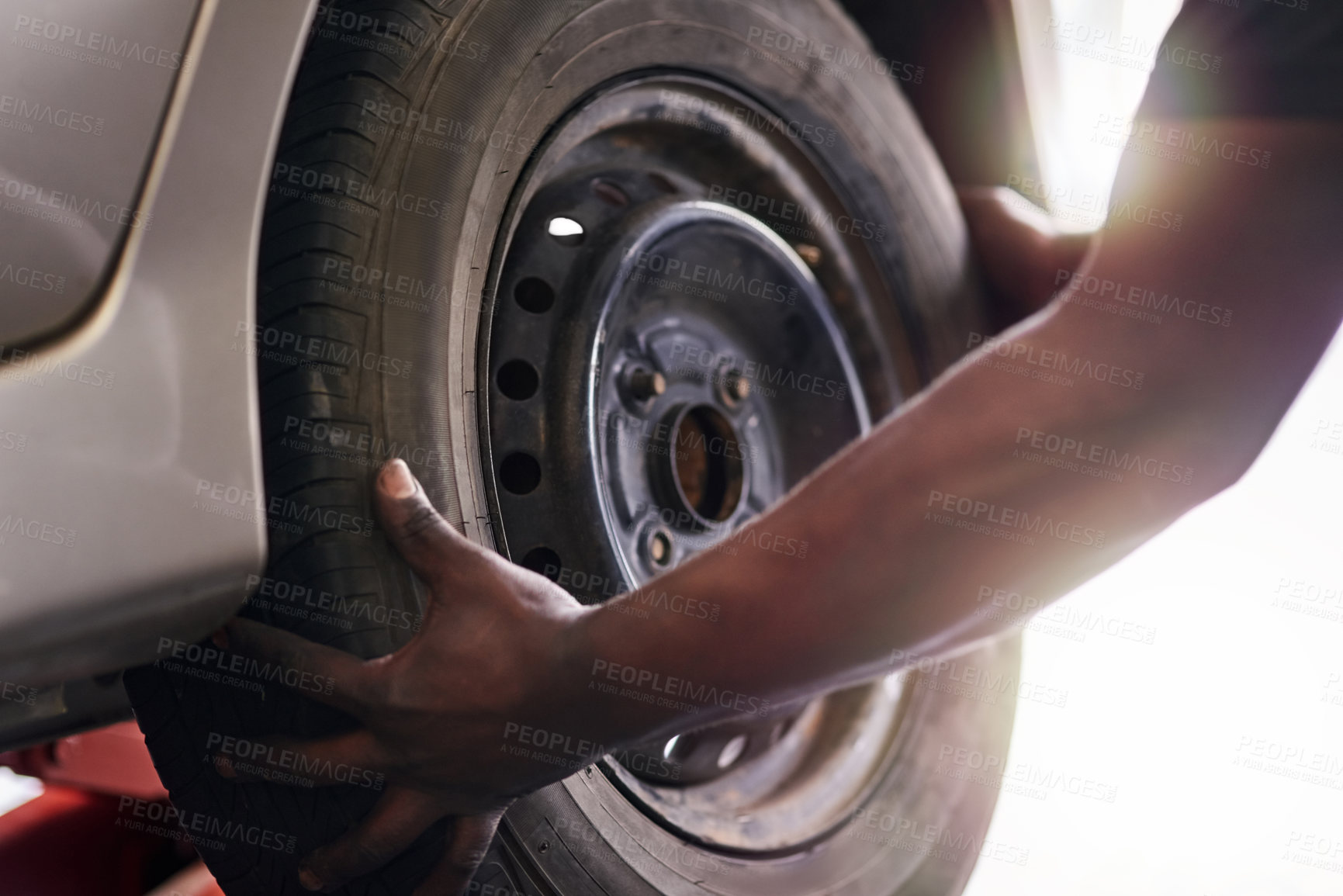 Buy stock photo Cropped shot of a mechanic repairing a car tyre