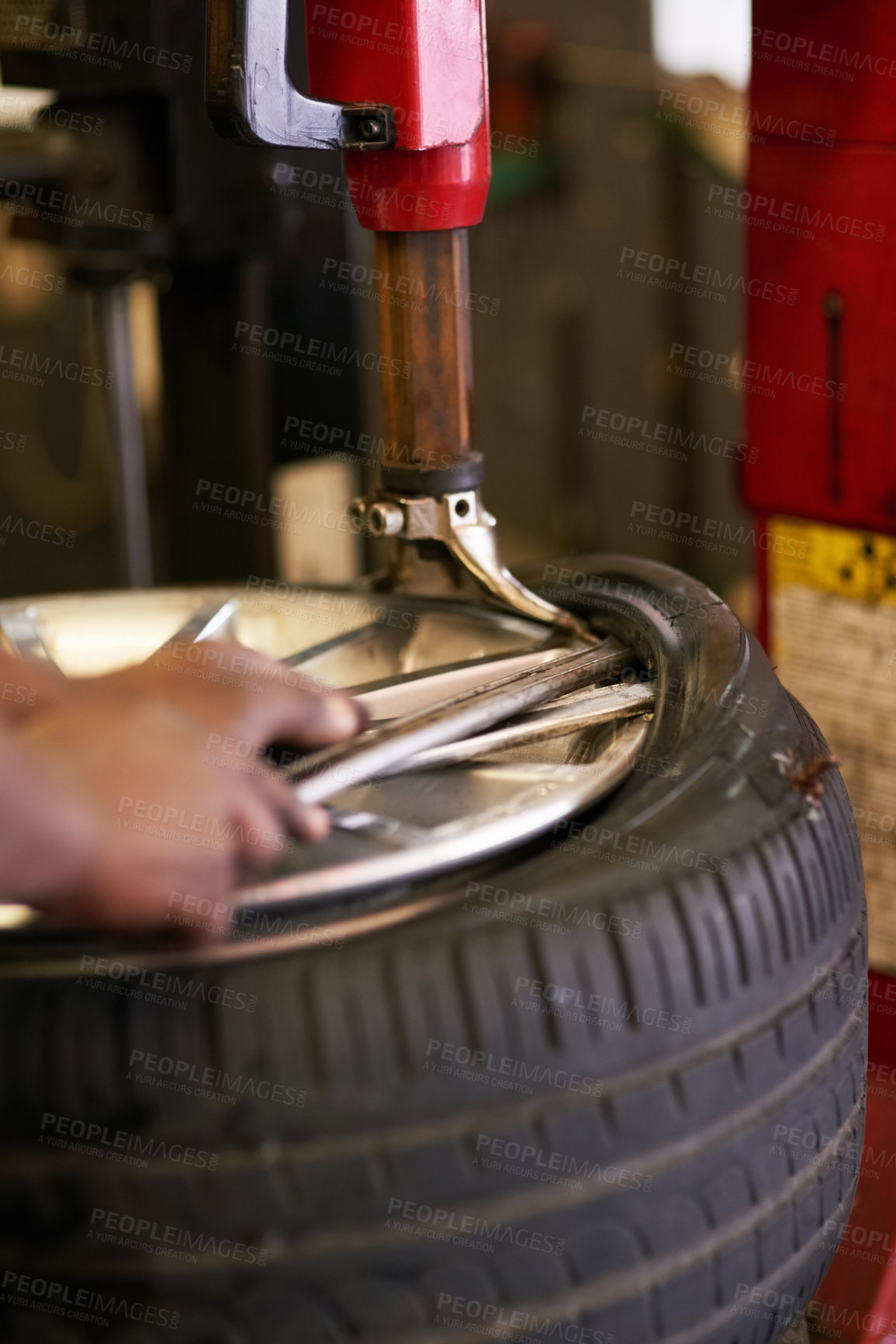 Buy stock photo Cropped shot of a mechanic repairing a car tyre