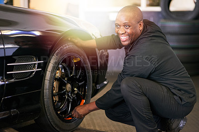 Buy stock photo Cropped shot of a mechanic repairing a car tyre