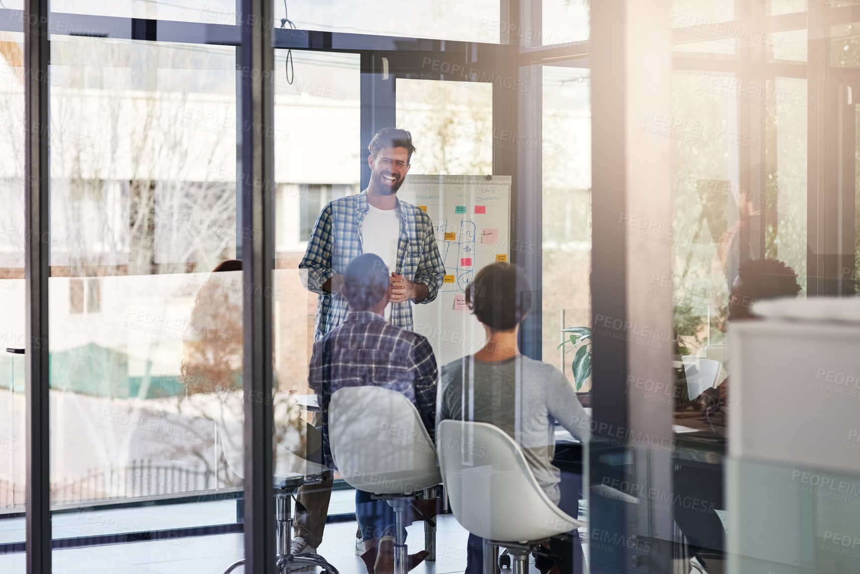 Buy stock photo Shot of a businessman giving a presentation to his colleagues in an office