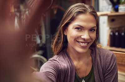 Buy stock photo Shot of an attractive young woman taking a selfie in a store