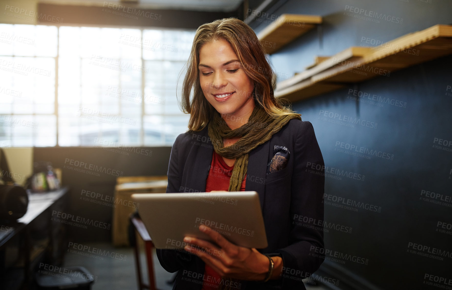 Buy stock photo Cropped shot of a young business owner using a digital tablet in her shop