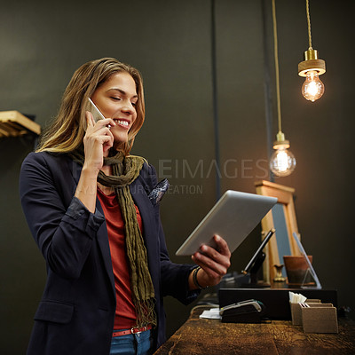 Buy stock photo Cropped shot of a young business owner using a digital tablet in her shop