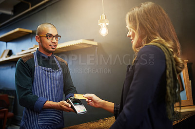 Buy stock photo Cropped shot of a customer paying using NFC technology in a shop