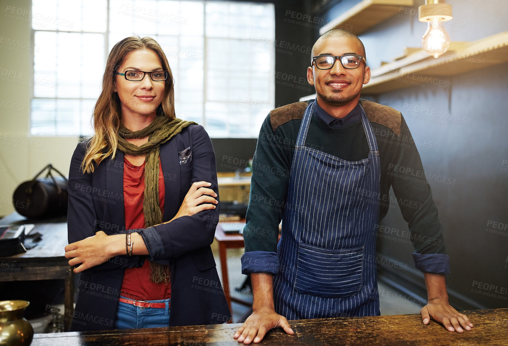 Buy stock photo Portrait of two young businesspeople standing in their shop