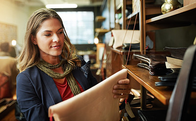 Buy stock photo Cropped shot of a young woman shopping in a leatherwork store