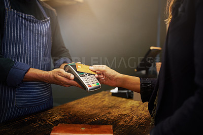 Buy stock photo Cropped shot of a customer paying using NFC technology in a shop