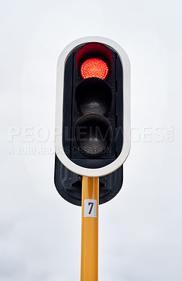 Buy stock photo Lights, stop and grey sky in urban area for speed control, safety and robot in the city. Traffic, metal and red light outdoor for direction, caution and sign on road for destination and drive.