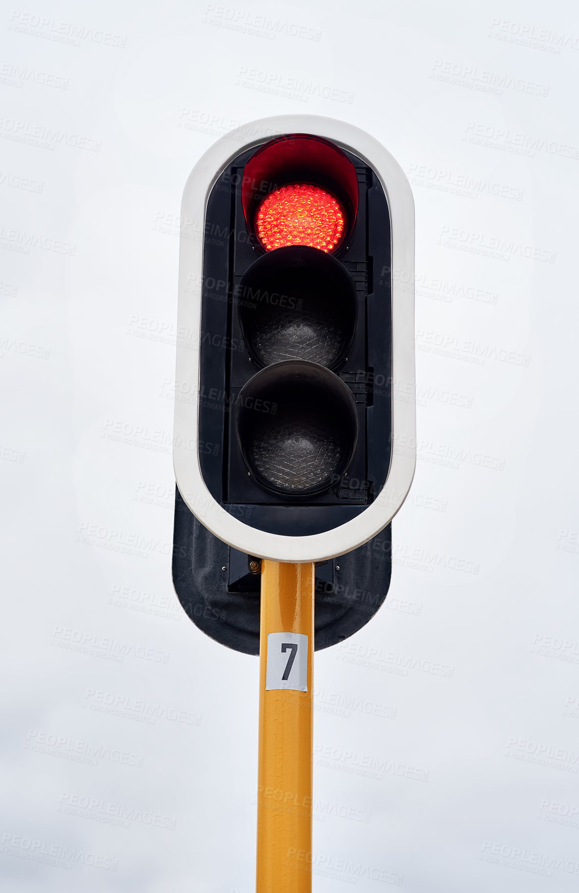 Buy stock photo Lights, stop and grey sky in urban area for speed control, safety and robot in the city. Traffic, metal and red light outdoor for direction, caution and sign on road for destination and drive.