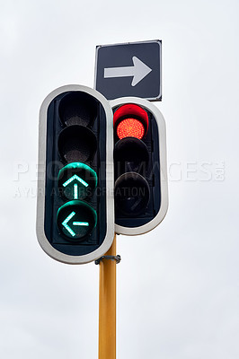 Buy stock photo Traffic light, green and arrow with stop at street intersection for transportation directions, driving or downtown. Road safety, urban and commute with outdoor caution or go signal, rules or city