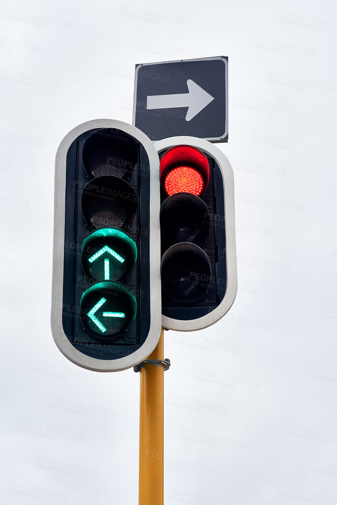 Buy stock photo Traffic light, green and arrow with stop at street intersection for transportation directions, driving or downtown. Road safety, urban and commute with outdoor caution or go signal, rules or city