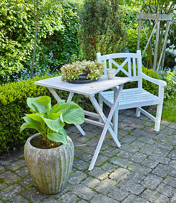 Buy stock photo Chair, garden and porch with table for zen or eco friendly environment by pot plant in nature. Empty, furniture or wood with natural bushes, flower or greenery for outdoor decor, growth or ecology