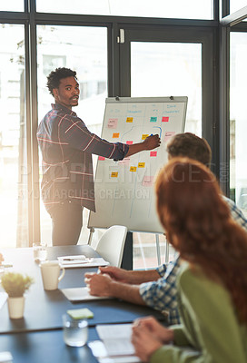 Buy stock photo Cropped shot of a businessman giving a presentation to his coworkers in a modern office