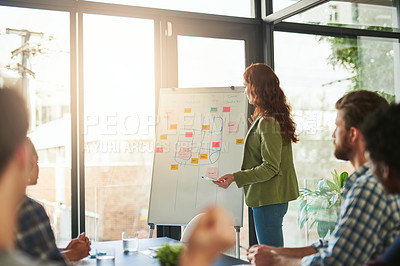 Buy stock photo Cropped shot of a businesswoman giving a presentation to her coworkers in a modern office