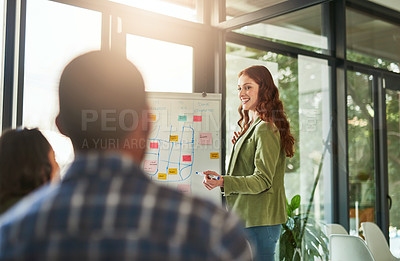 Buy stock photo Cropped shot of a businesswoman giving a presentation to her coworkers in a modern office