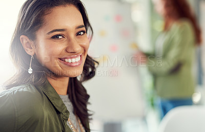 Buy stock photo Portrait of a young businesswoman sitting in a modern office with her colleagues
