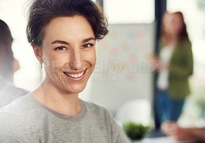 Buy stock photo Portrait of a young businesswoman sitting in a modern office with her colleagues