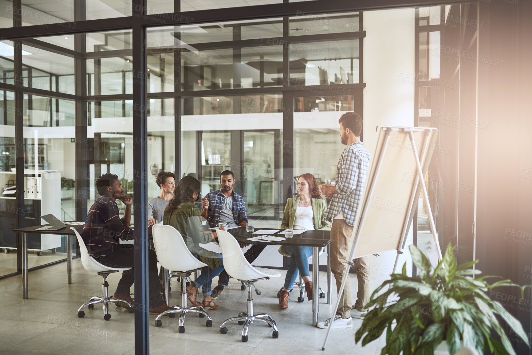 Buy stock photo Shot of a businessman giving a presentation to his coworkers in a modern office