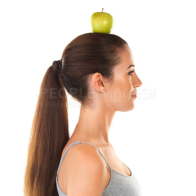 Buy stock photo Woman, apple and balance on head for health, nutrition and wellness as fruit for diet on studio backdrop in profile. Female person, food and benefits of organic, fiber and vitamin C for skincare