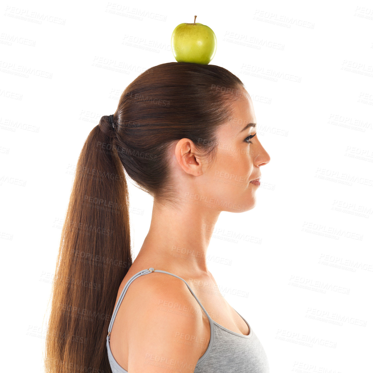 Buy stock photo Woman, apple and balance on head for health, nutrition and wellness as fruit for diet on studio backdrop in profile. Female person, food and benefits of organic, fiber and vitamin C for skincare