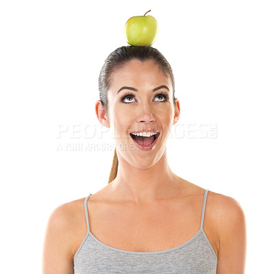 Buy stock photo Woman, health and apple on head in studio on white background for digestion, nutrition and snack. Female person, happy and fruit fresh for organic vegan, food or diet for self care and wellness