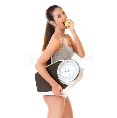 Buy stock photo Woman, happy and scale with apple in studio on white background for body weight, progress and fat loss with fitness. Portrait, healthy and diet or nutrition with self care for health in smile